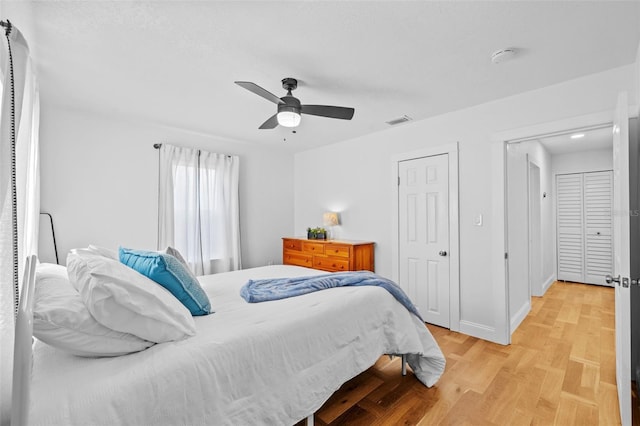 bedroom with ceiling fan and light wood-type flooring