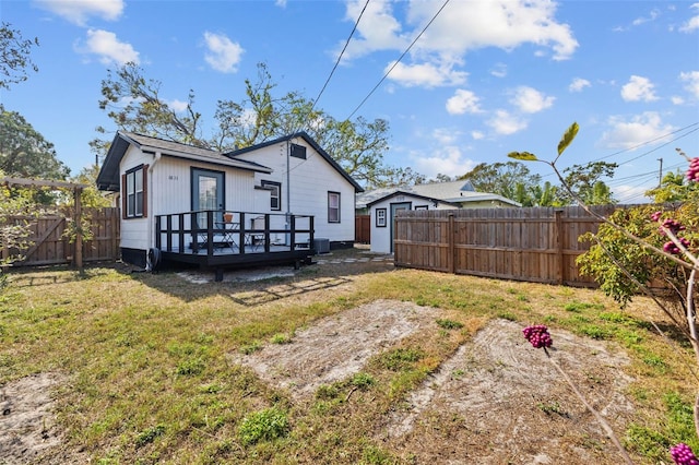 back of house featuring a yard and a deck