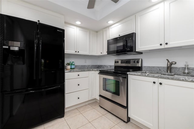 kitchen featuring white cabinetry, light tile patterned flooring, and black appliances