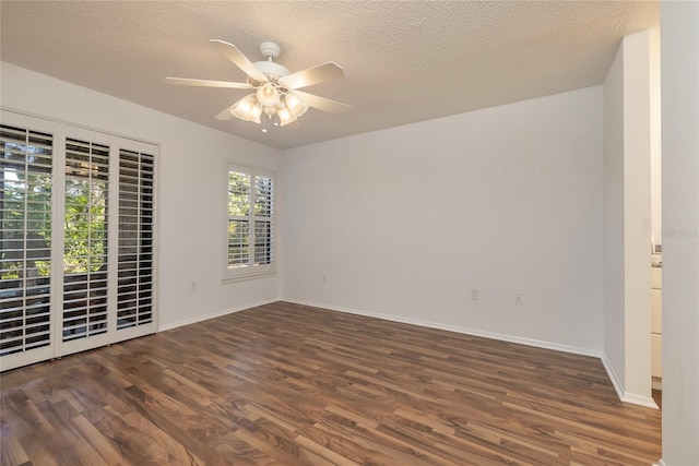 unfurnished room featuring dark hardwood / wood-style flooring, ceiling fan, and a textured ceiling