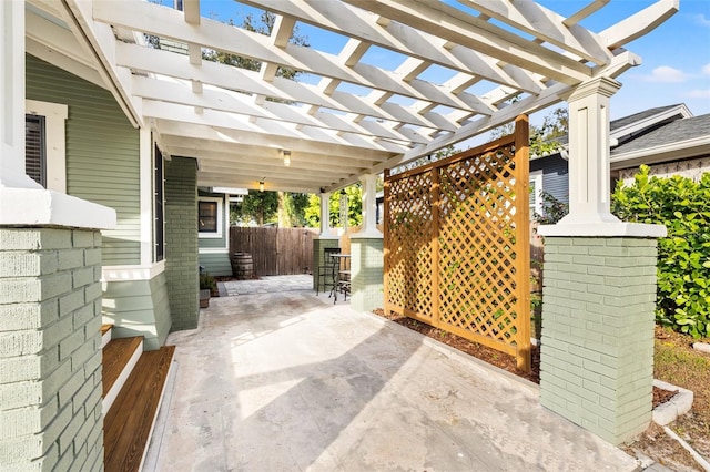 view of patio with exterior bar and a pergola