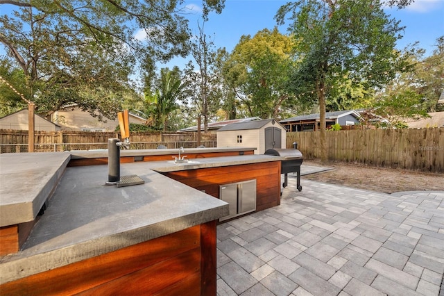 view of patio / terrace featuring area for grilling, grilling area, and a shed