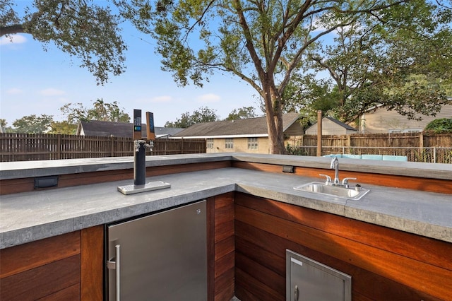 view of patio / terrace featuring an outdoor kitchen and sink