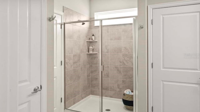 bathroom featuring a shower with door