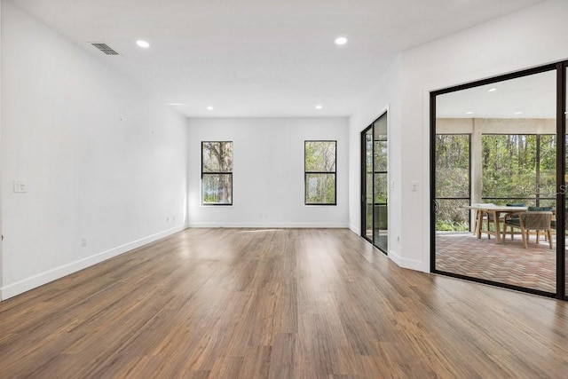 unfurnished room featuring hardwood / wood-style flooring