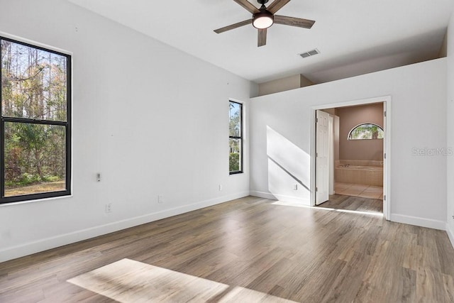 empty room with hardwood / wood-style floors and ceiling fan