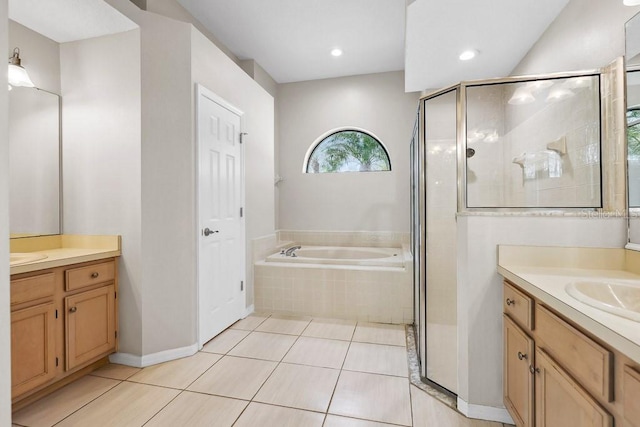 bathroom featuring tile patterned flooring, plus walk in shower, and vanity