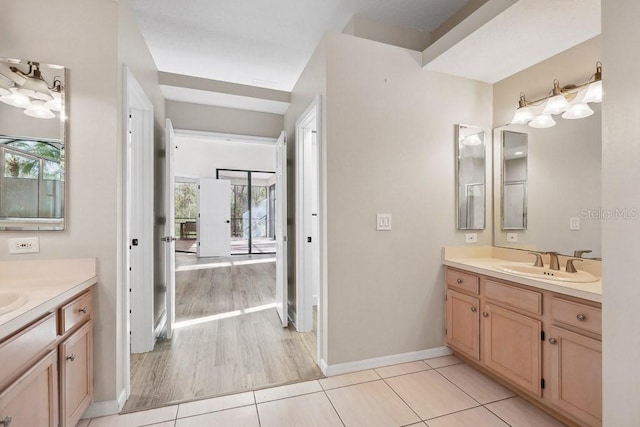 bathroom with vanity, a wealth of natural light, and tile patterned floors