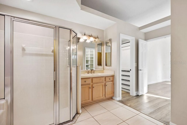 bathroom featuring vanity, an enclosed shower, and tile patterned floors