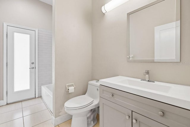 bathroom featuring tile patterned floors, vanity, and toilet