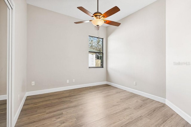 unfurnished room featuring hardwood / wood-style flooring and ceiling fan