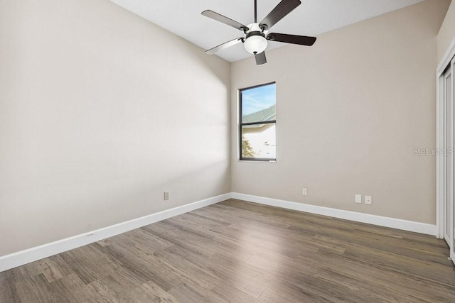 unfurnished bedroom with dark hardwood / wood-style flooring and ceiling fan