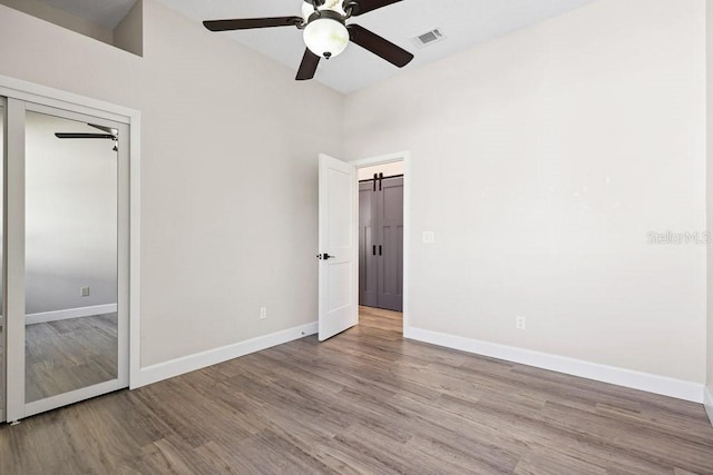 unfurnished bedroom with ceiling fan and light wood-type flooring