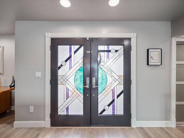 foyer featuring french doors and light hardwood / wood-style floors