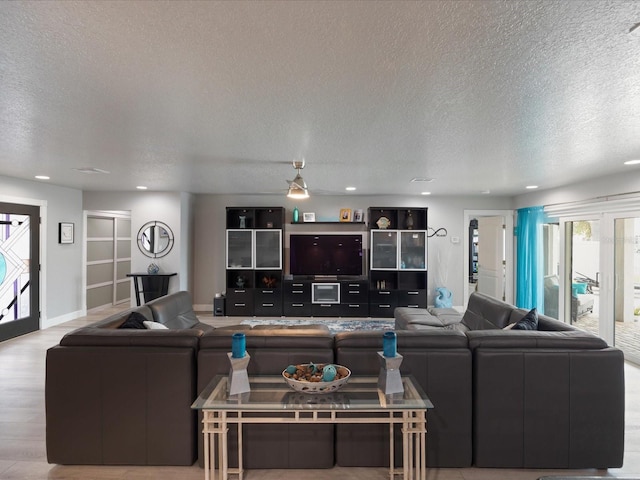 living room with light hardwood / wood-style floors and a textured ceiling