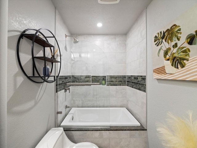 bathroom with tiled shower / bath combo and a textured ceiling