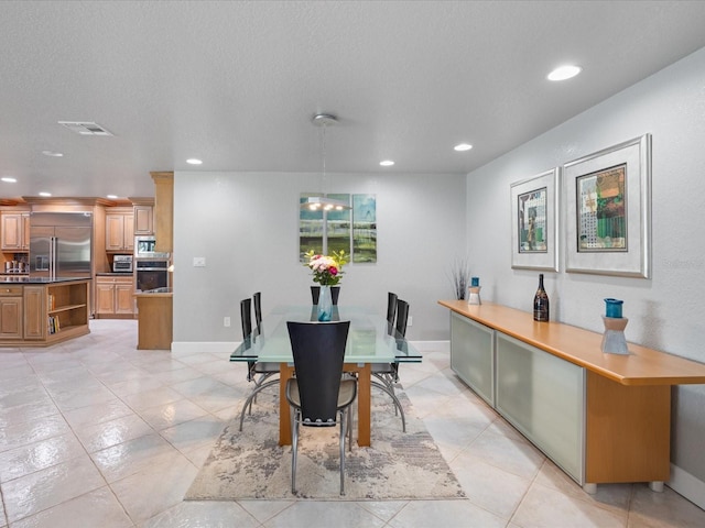 dining room with light tile patterned floors and a textured ceiling