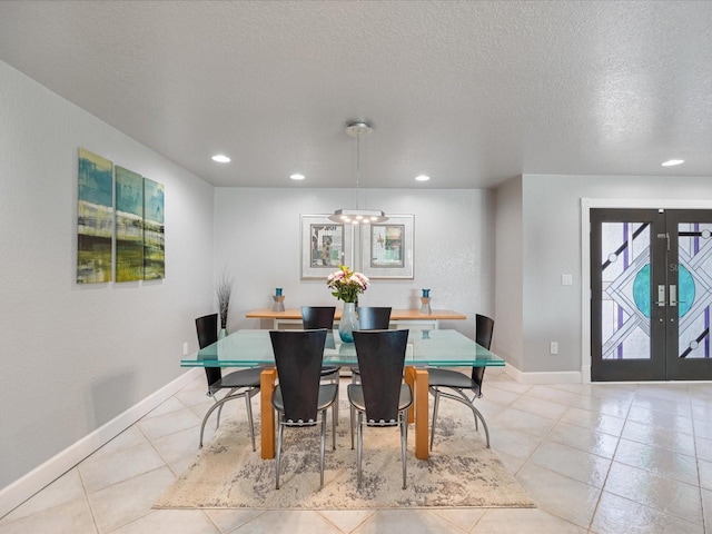 dining room with french doors, an inviting chandelier, a textured ceiling, and light tile patterned floors