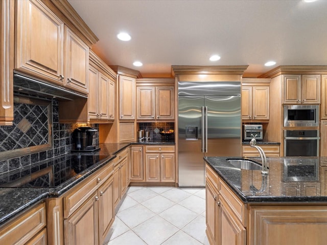 kitchen featuring light tile patterned flooring, sink, backsplash, dark stone counters, and built in appliances