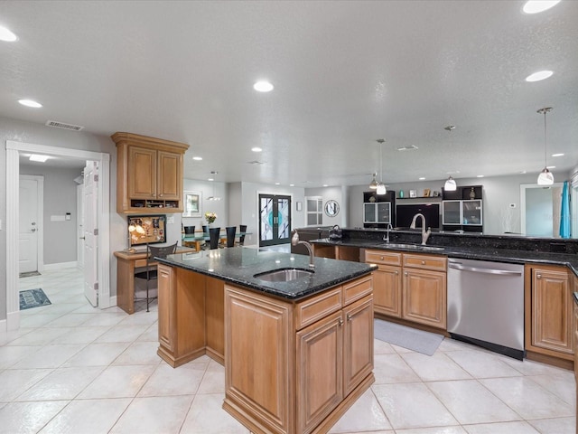 kitchen featuring sink, dark stone countertops, hanging light fixtures, a kitchen island with sink, and stainless steel dishwasher