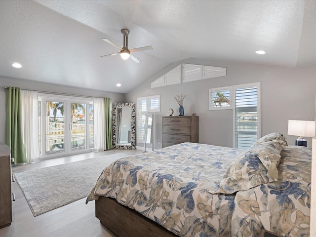 bedroom with ceiling fan, vaulted ceiling, and a textured ceiling