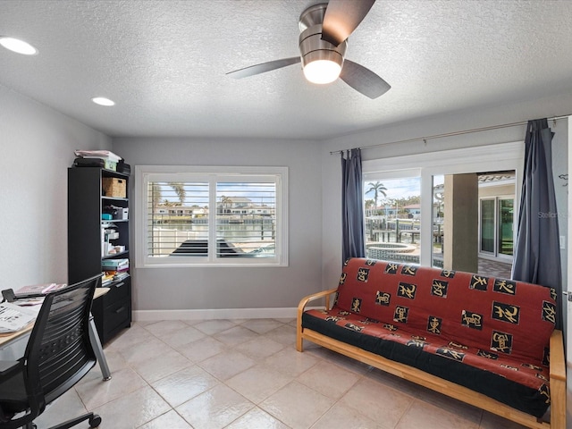 bedroom with a textured ceiling and ceiling fan