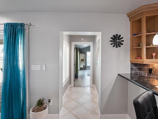 corridor featuring light tile patterned flooring