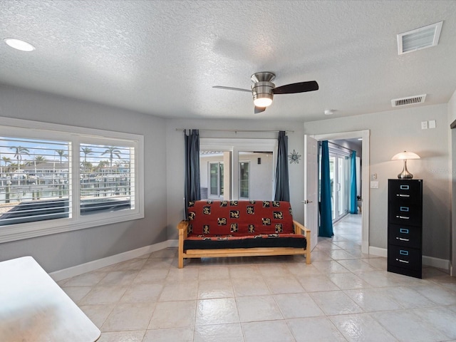 bedroom featuring ceiling fan and a textured ceiling