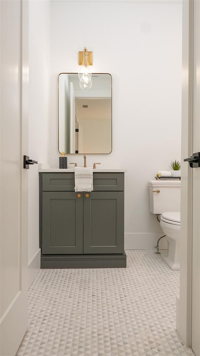 bathroom featuring vanity and toilet