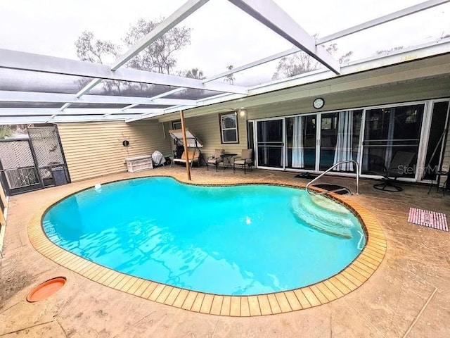 view of pool featuring a patio and glass enclosure