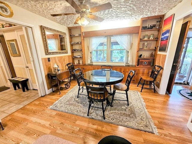 dining area featuring ceiling fan, a textured ceiling, and light wood-type flooring