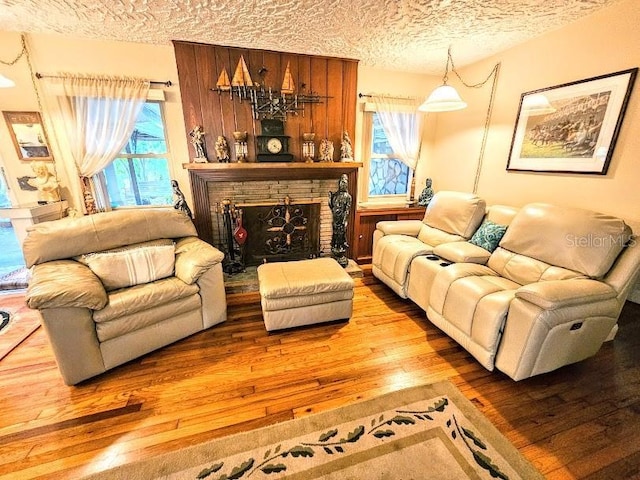 living room featuring hardwood / wood-style flooring, a textured ceiling, and a wealth of natural light