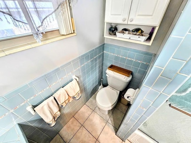 bathroom featuring tile walls, tile patterned floors, and toilet