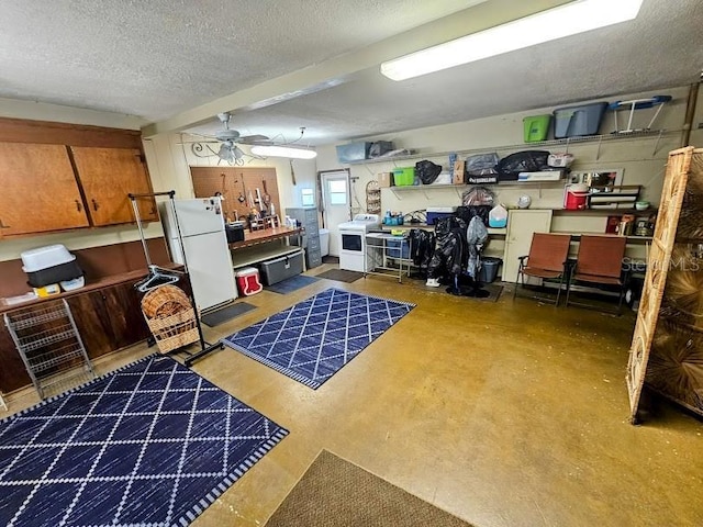 interior space with washer / clothes dryer, concrete flooring, ceiling fan, and a textured ceiling