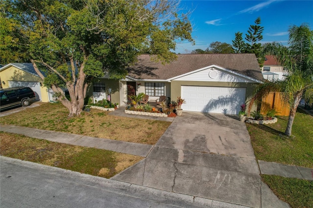 single story home with a garage and a front lawn