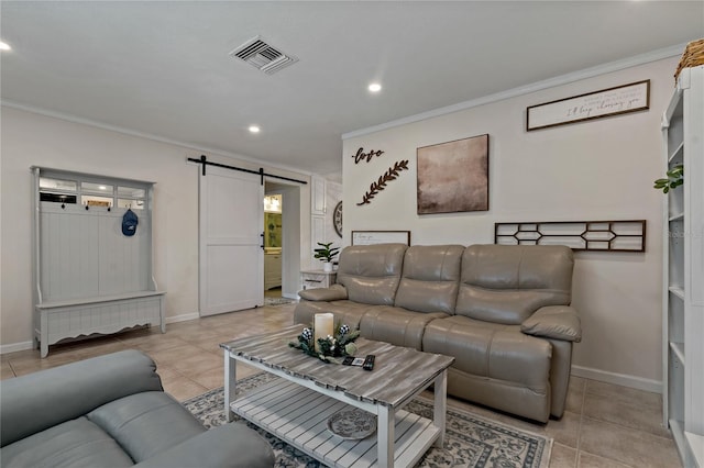 living room featuring crown molding, a barn door, and light tile patterned floors