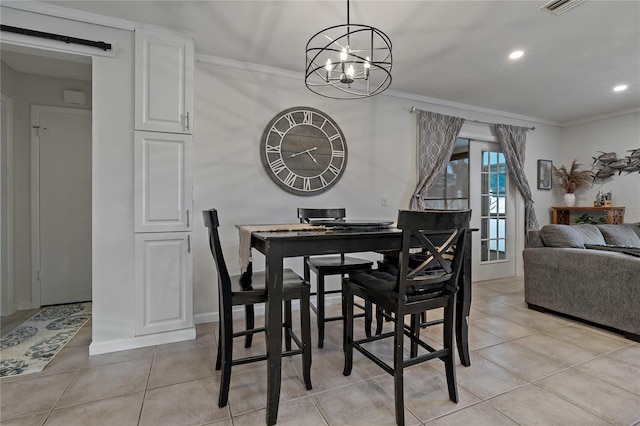 dining space featuring ornamental molding, a barn door, and light tile patterned floors