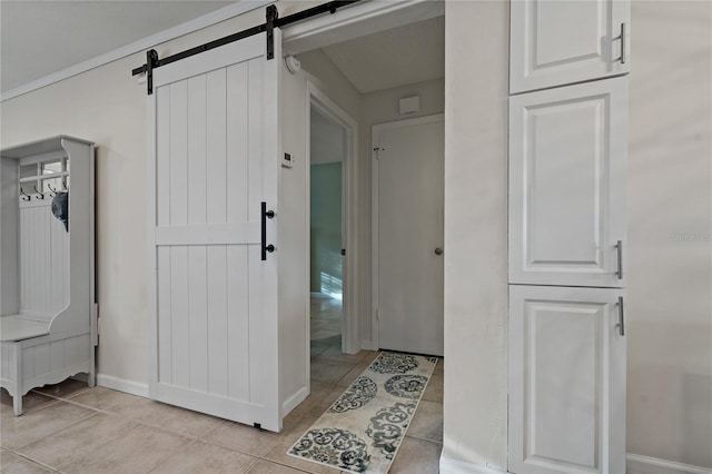 interior space featuring a barn door and light tile patterned floors