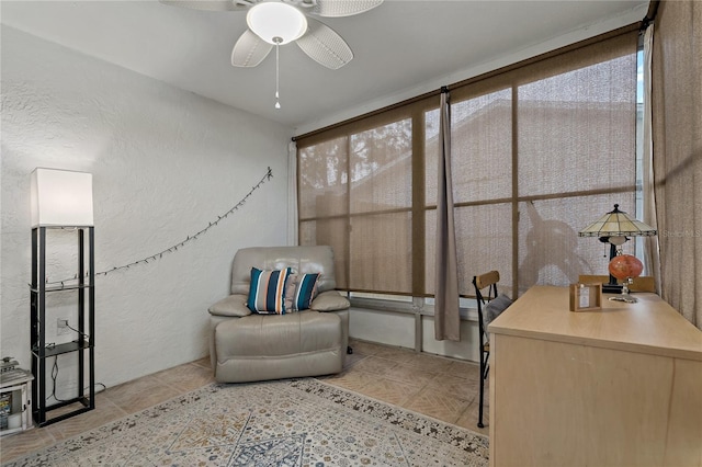 living area featuring ceiling fan and a wealth of natural light