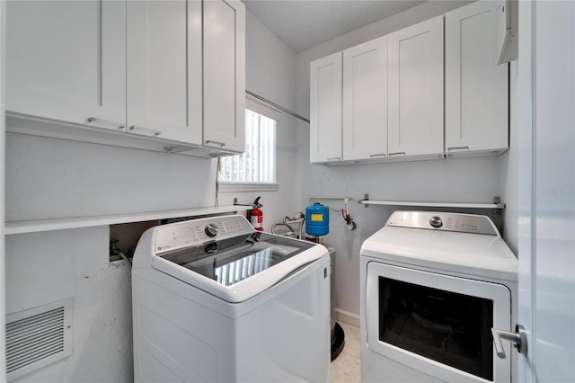 laundry room featuring cabinets and independent washer and dryer