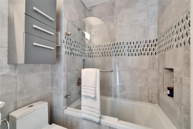 bathroom with shower / tub combo and toilet