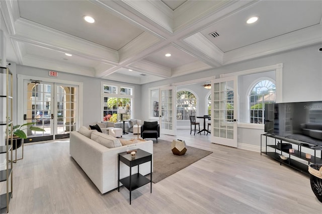 living room featuring french doors, plenty of natural light, and beamed ceiling