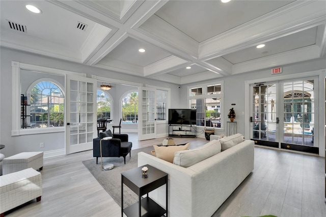 living room featuring coffered ceiling, light hardwood / wood-style flooring, french doors, and beamed ceiling