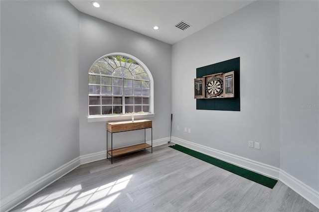 empty room with light hardwood / wood-style flooring