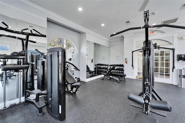 exercise room featuring crown molding