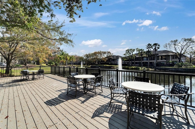 wooden terrace featuring a water view