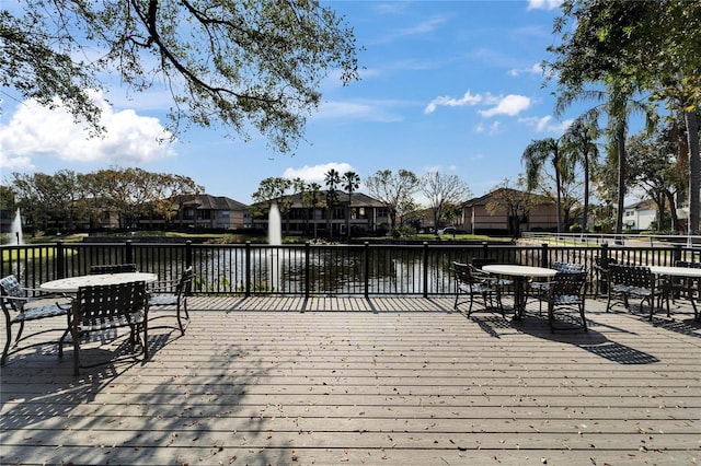 wooden terrace featuring a water view