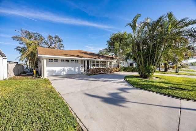 ranch-style home with a garage and a front lawn