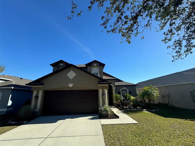 view of front facade with a garage and a front lawn