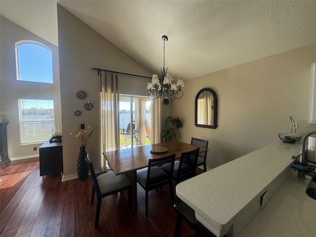 dining space with vaulted ceiling, dark wood-type flooring, a notable chandelier, and a textured ceiling